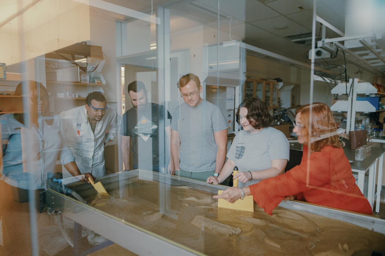 Students and faculty researching the water channels in lab